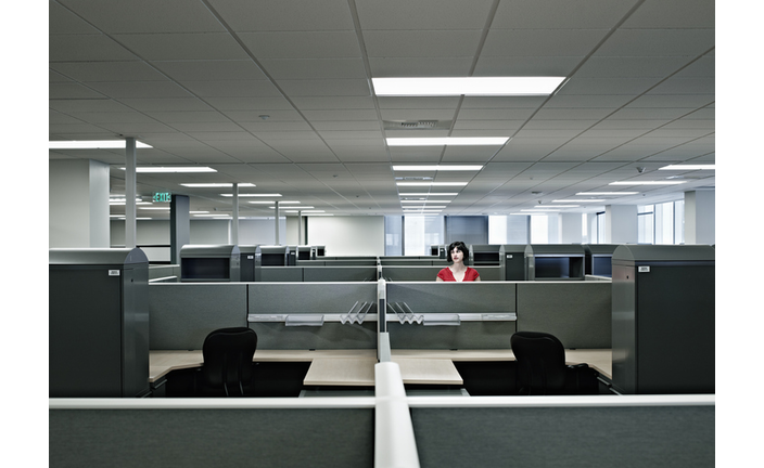 Businesswoman standing alone in empty office