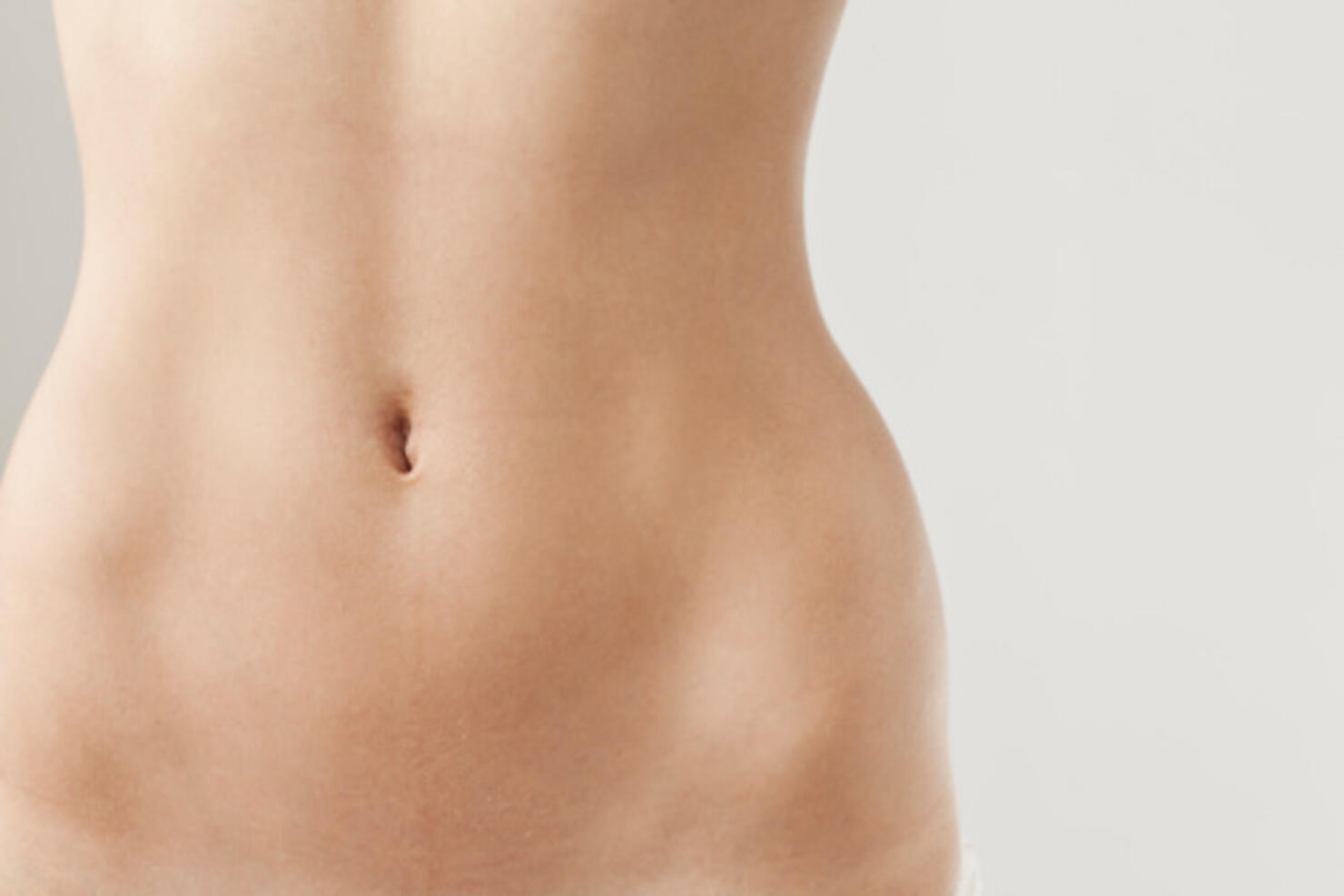 Detail view of womans naked belly