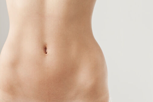 Detail view of womans naked belly