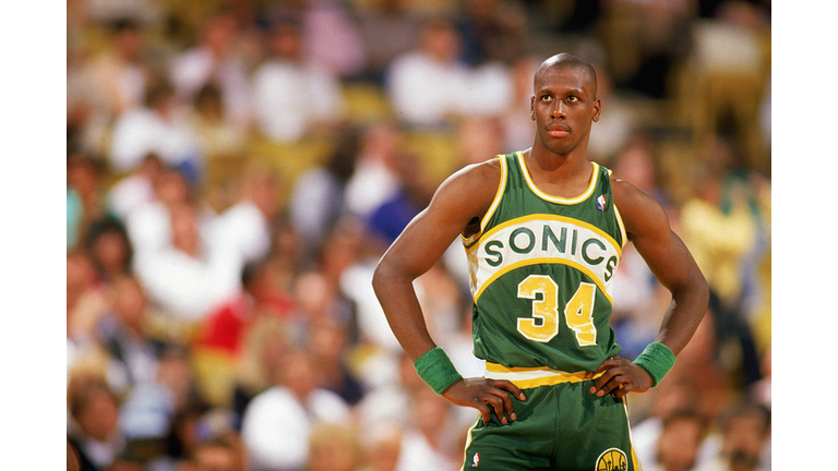 Xavier McDaniel looks on