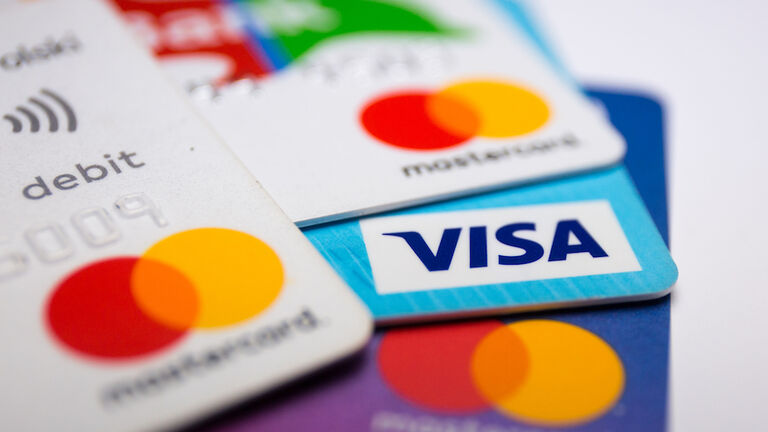 In this photo illustration a Visa credit card and Mastercard