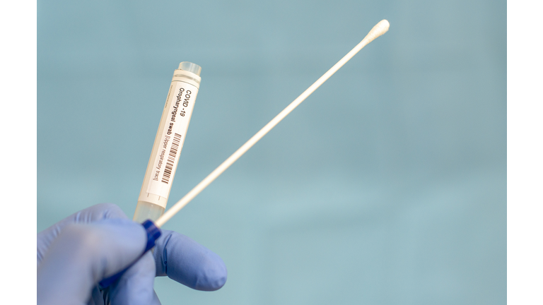 Cotton swab and test tube for Coronavirus test (COVID-19)), macro image of medical equipment in hands of healthcare professional