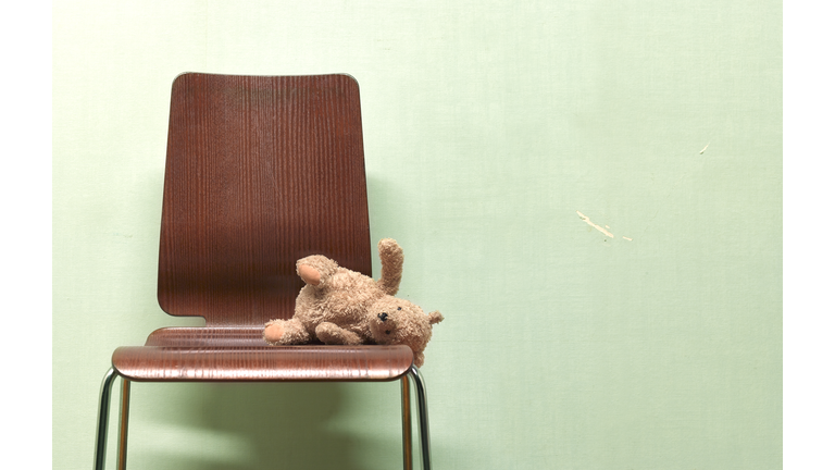 CHILDS FORGOTTEN, ABANDONED TEDDY ON CHAIR