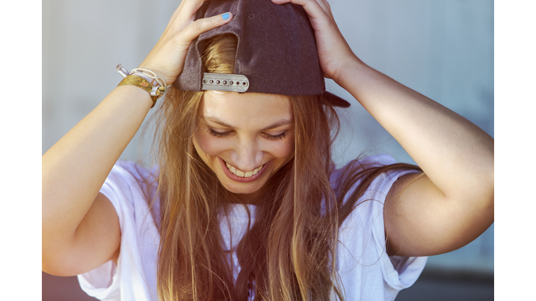 Portrait of young woman wearing baseball cap