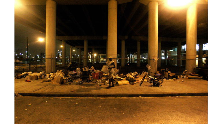 A homeless man packs his belongings on a