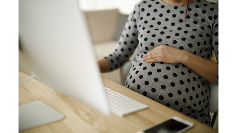 Pregnant woman working from home office