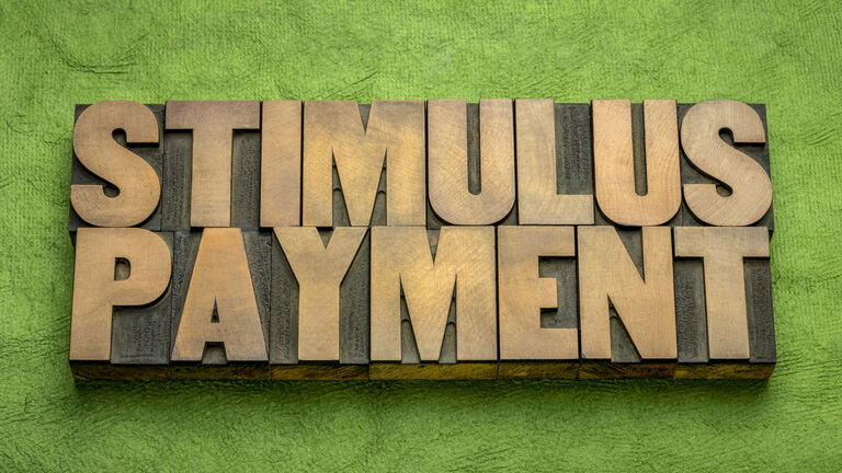 stimulus payment word abstract in wood type