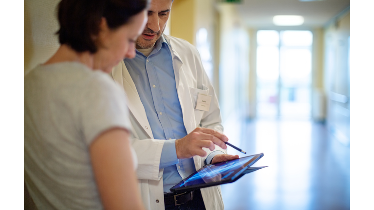 Doctor showing x-ray to a woman patient