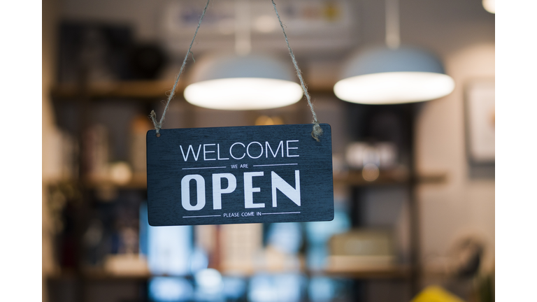 Store open sign hanging on the window