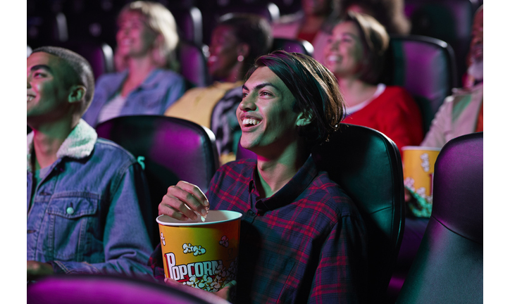 Happy audience watching movie in cinema hall