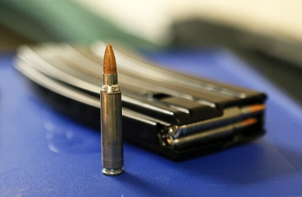 .223 AR-15 ammunition and a high capacity 30 round clip sits on the table at the "Get Some Guns & Ammo" shooting range.