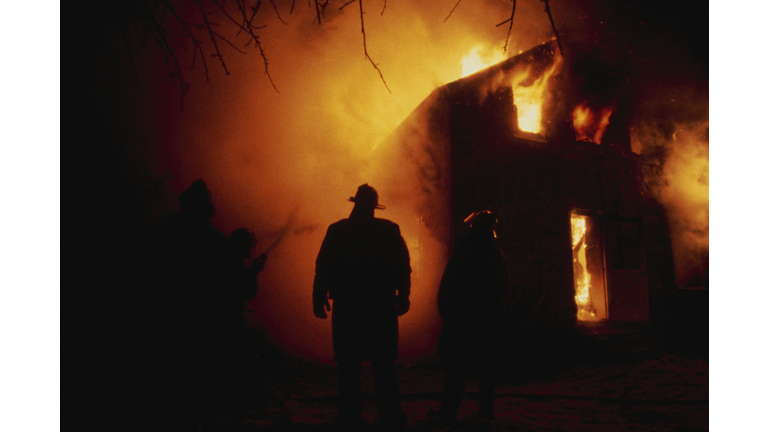 Firefighter By Flaming House