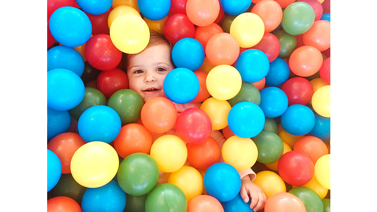 Directly Above Portrait Of Baby Girl In Ball Pool