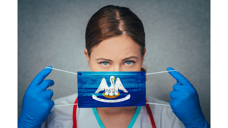 Coronavirus in U.S. State Louisiana, Female Doctor Portrait, protect Face surgical medical mask with Louisiana Flag. Illness, Virus Covid-19 in Louisiana