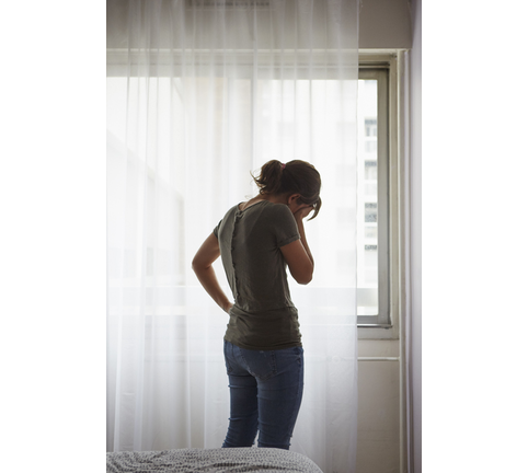 Woman contemplating in bedroom