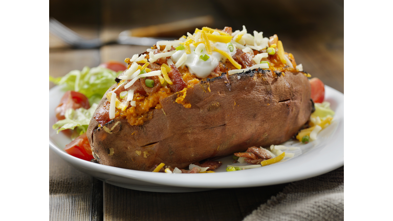 Loaded, Twice Baked Sweet Potato with Bacon, Cheese, Green Onions and Sour Cream and a Side Salad