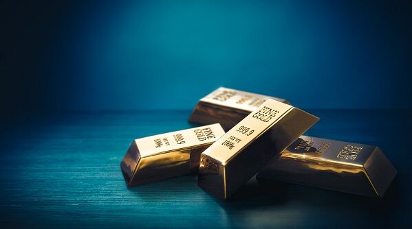 Pile of gold bars or ingots on a dark background