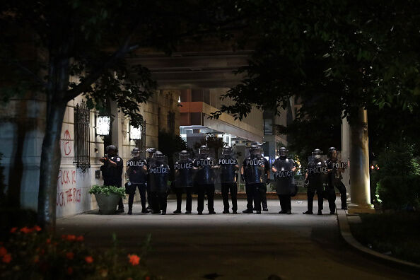 Police hold a perimeter on the driveway of Hay-Adams Hotel near the White House as demonstrators gather to protest the killing of George Floyd on May 30, 2020 in Washington, DC.