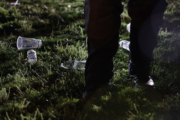 A member of the U.S. Secret Service stands next to water bottles that were thrown over by protesters as he holds a perimeter near the White House as demonstrators gather to protest the killing of George Floyd.