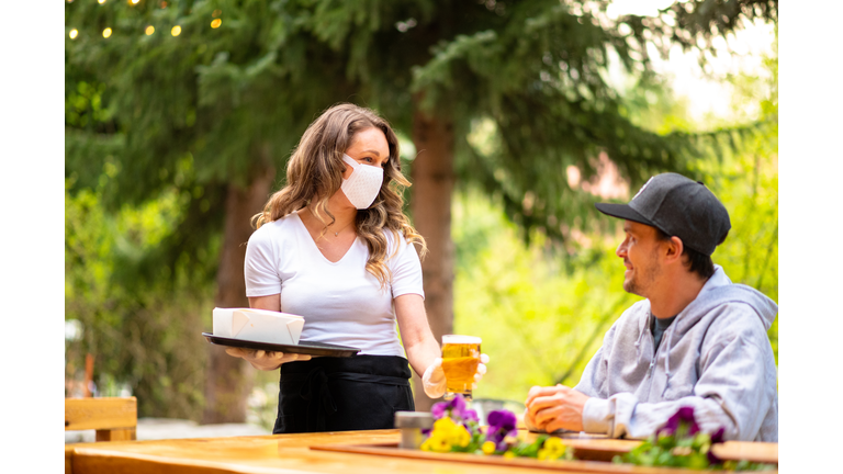 Waitress wearing protective equipment for COVID