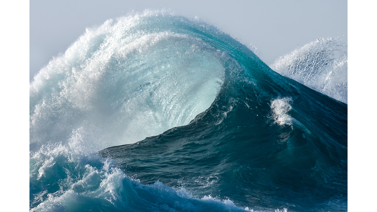 Large wave splashing in blue sea