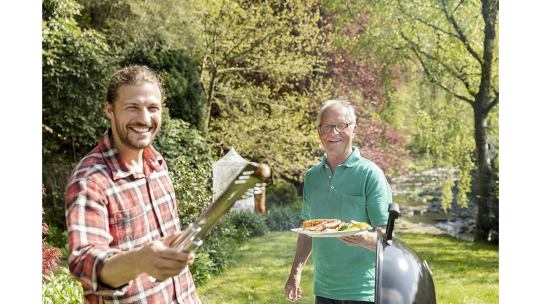 Portrait of happy man on a family barbecue in garden