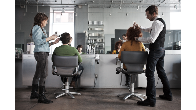 clients getting haircuts in salon