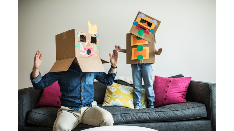 Father and daughter wearing robot costumes at home