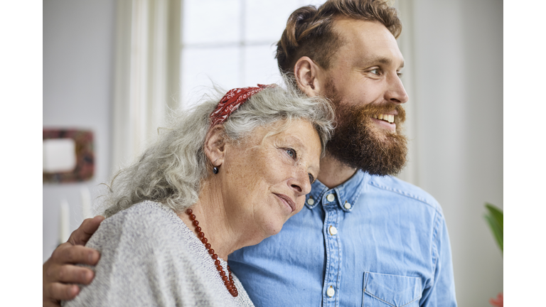 Mother and smiling adult son