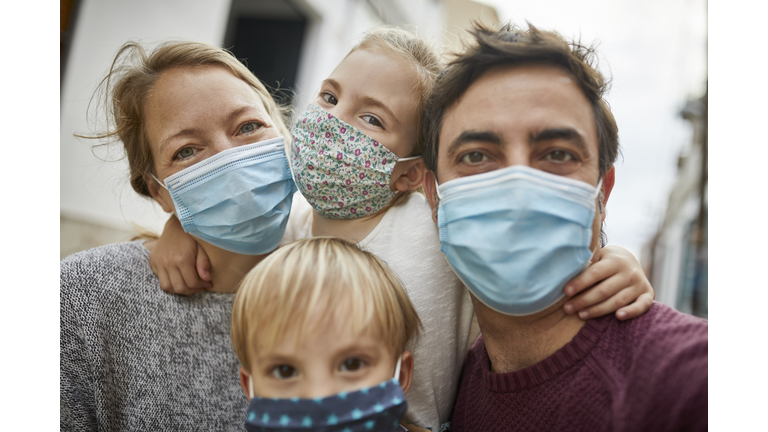 Real Family Taking a Selfie Together While Wearing Protective Face Masks