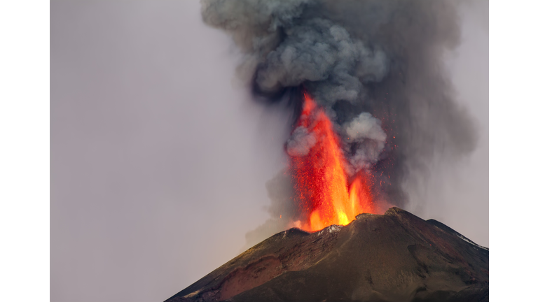 Smoke Emitting From Volcanic Mountain Against Sky