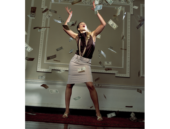 Woman surrounded by falling banknotes