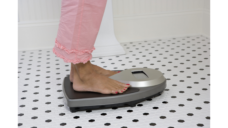 Woman weighing herself