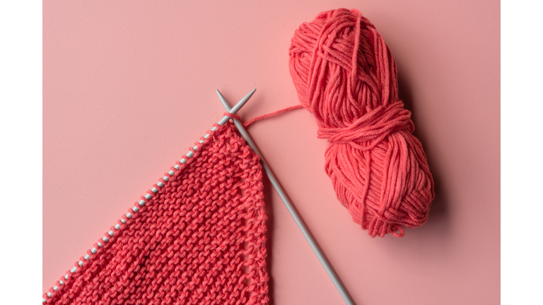 Directly Above Shot Of Knitting Needle With Crochet On Colored Background