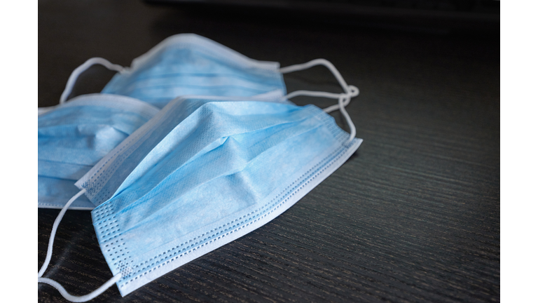 Respiratory mask on desk in office, Protective medical mask with 2019-nCoV, Coronavirus protection concept.