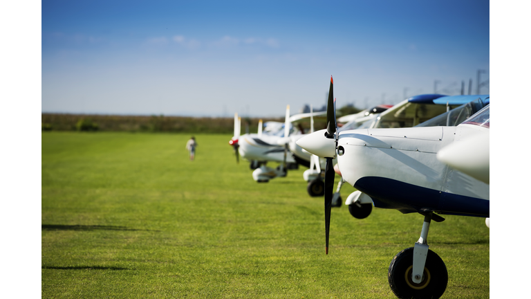 Small sports airplanes in a row