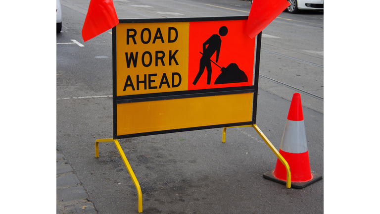'Road work ahead' sign in a city street