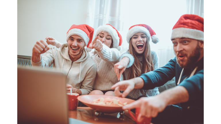 Group of Excited Friend Drink Hot Drink and Watch Interesting Football Game for The Holidays