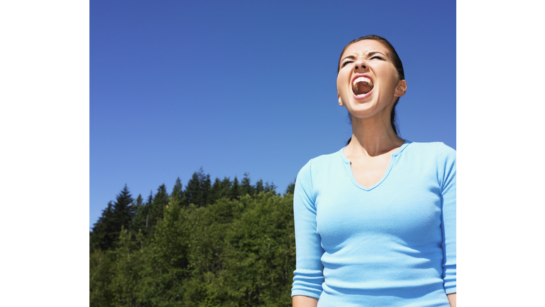 Woman yelling outdoors