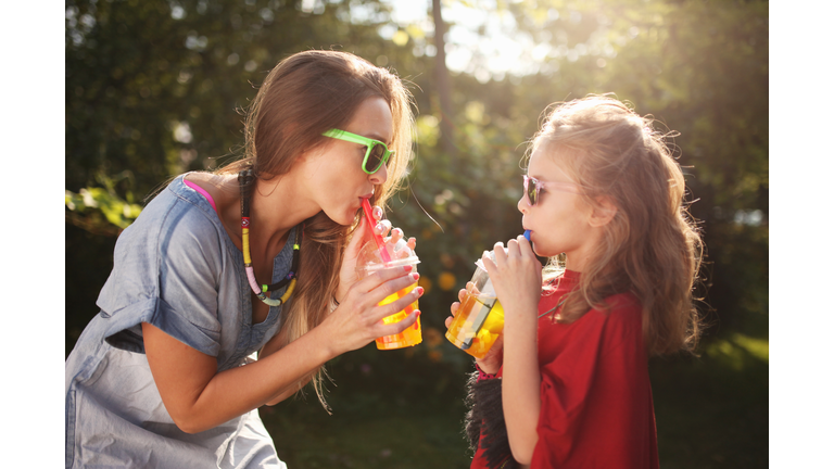 Mother with daughter enjoying bubble tea