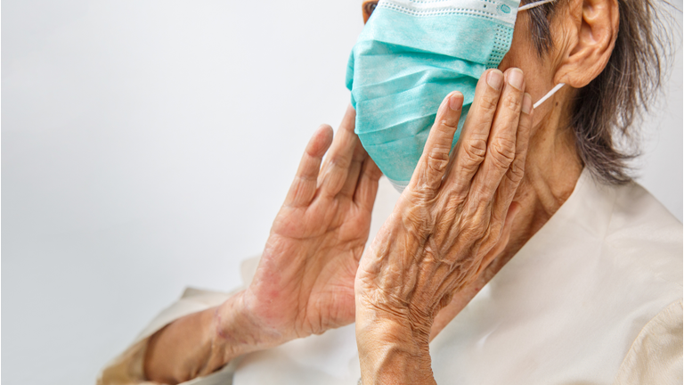 Elderly woman wearing a mask to protect from coronavirus covid-19