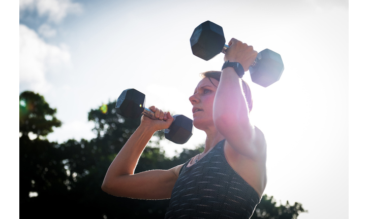 Women doing her fitness routing at home in her back garden