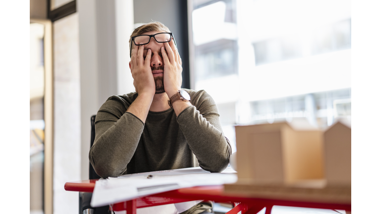 Exhausted architect in office