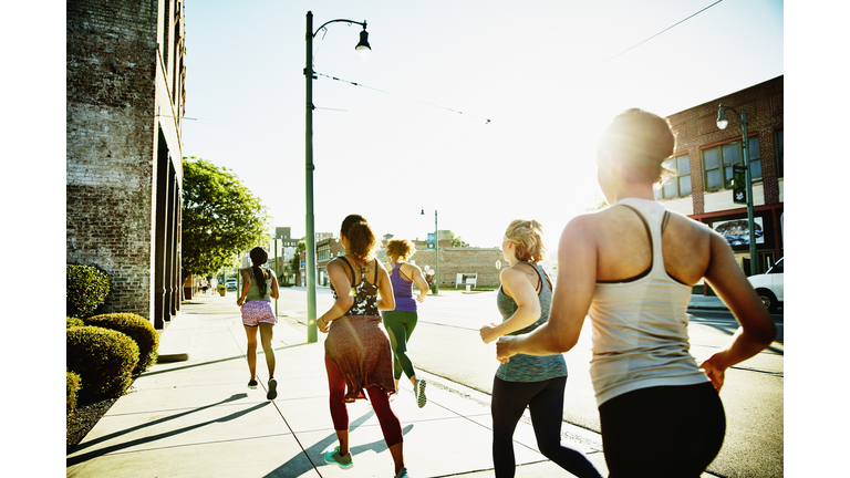 Group of women on morning run on sidewalk