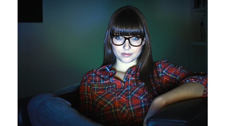 Young woman watching television