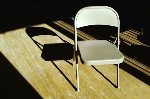 High Angle View Of Empty Foldable Chair On Floorboard