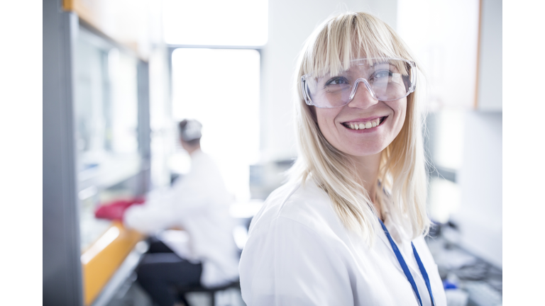 Doctor wearing protective goggles and smiling