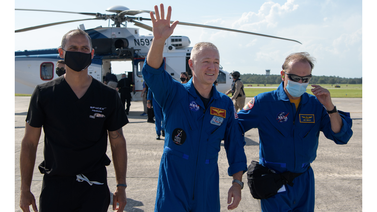 In this handout image provided by NASA, NASA astronaut Douglas Hurley waves to onlookers as he boards a plane departing for Houston at Naval Air Station Pensacola on August 2, 2020 in Pensacola, Florida. (Photo by Bill Ingalls/NASA via Getty Images)