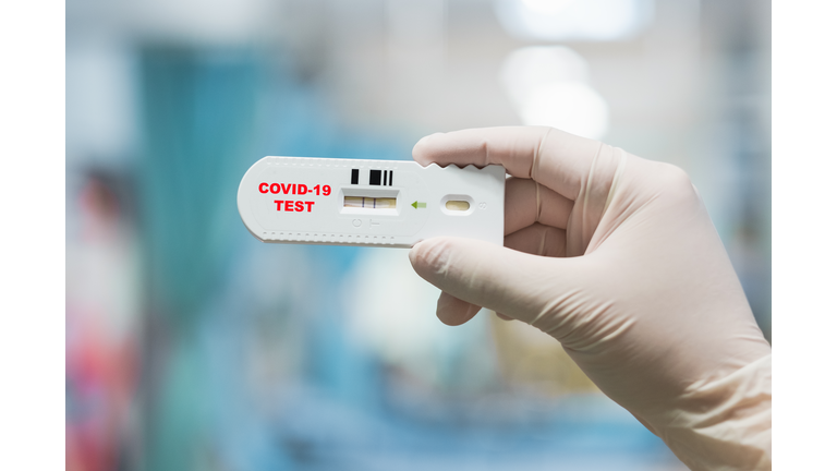 Doctor hand holding positive Coronavirus or Covid-19 rapid test