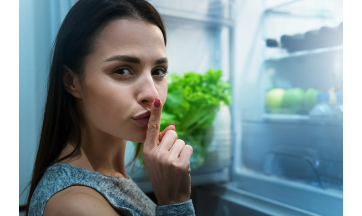 Girl getting secretly to eat from fridge at night